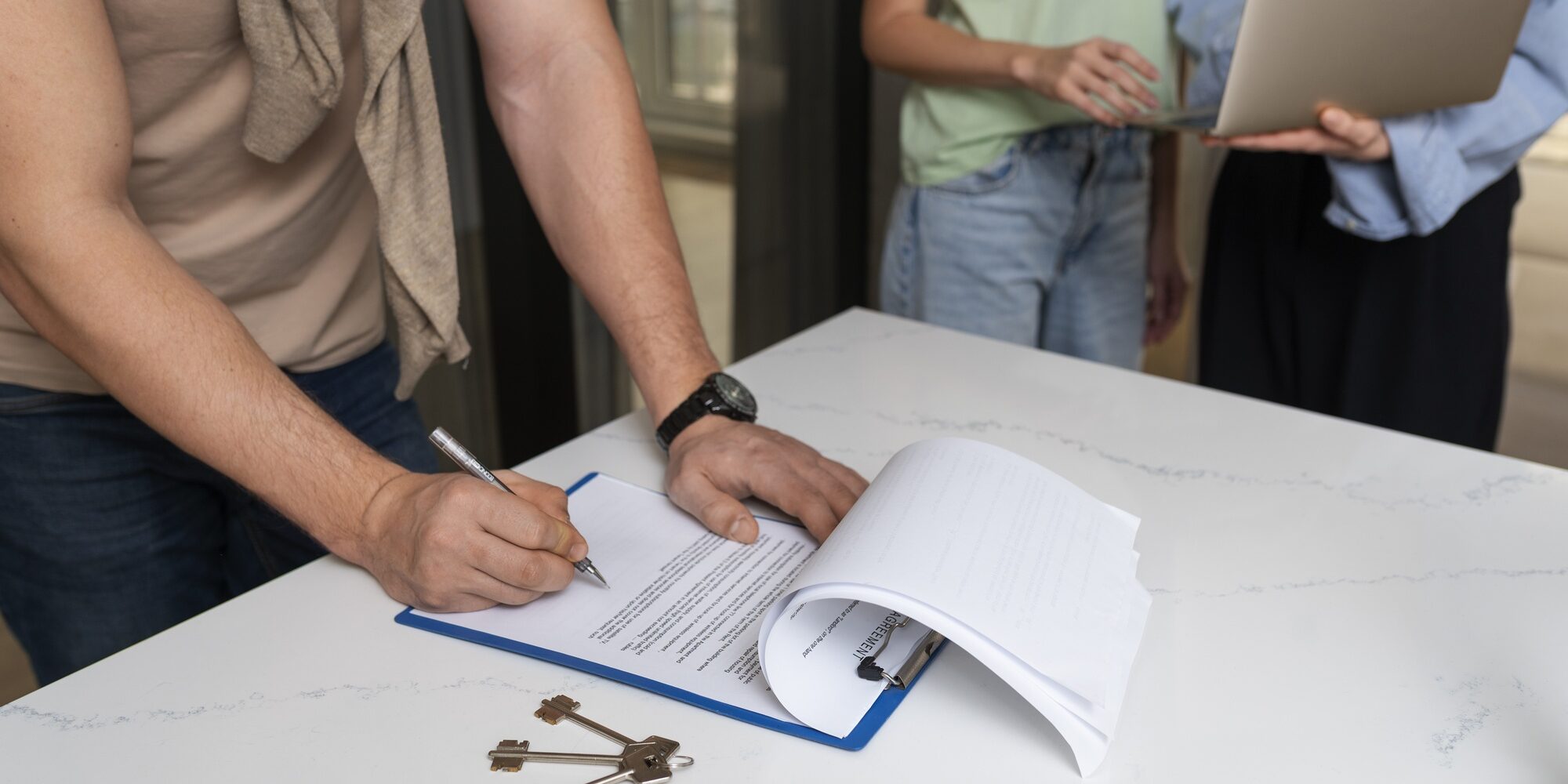 side-view-buyer-signing-document