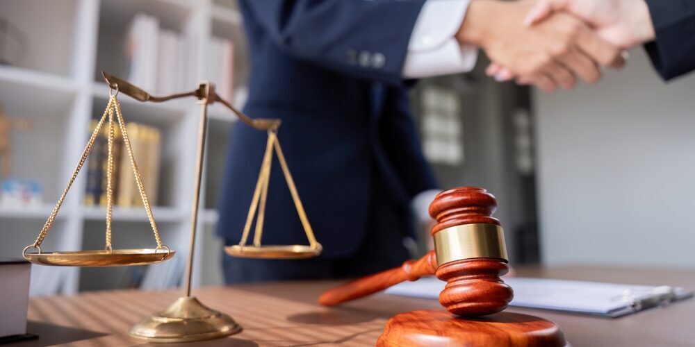 Professional,Lawyer,Handshake,In,Business,Meeting,With,Scales,Of,Justice trust attorney Fort Worth